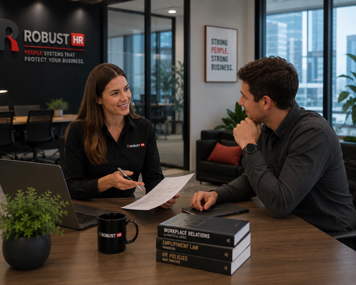 A Robust HR consultant reviewing workplace relations, employment law and HR policy documents with a client in a Perth office
